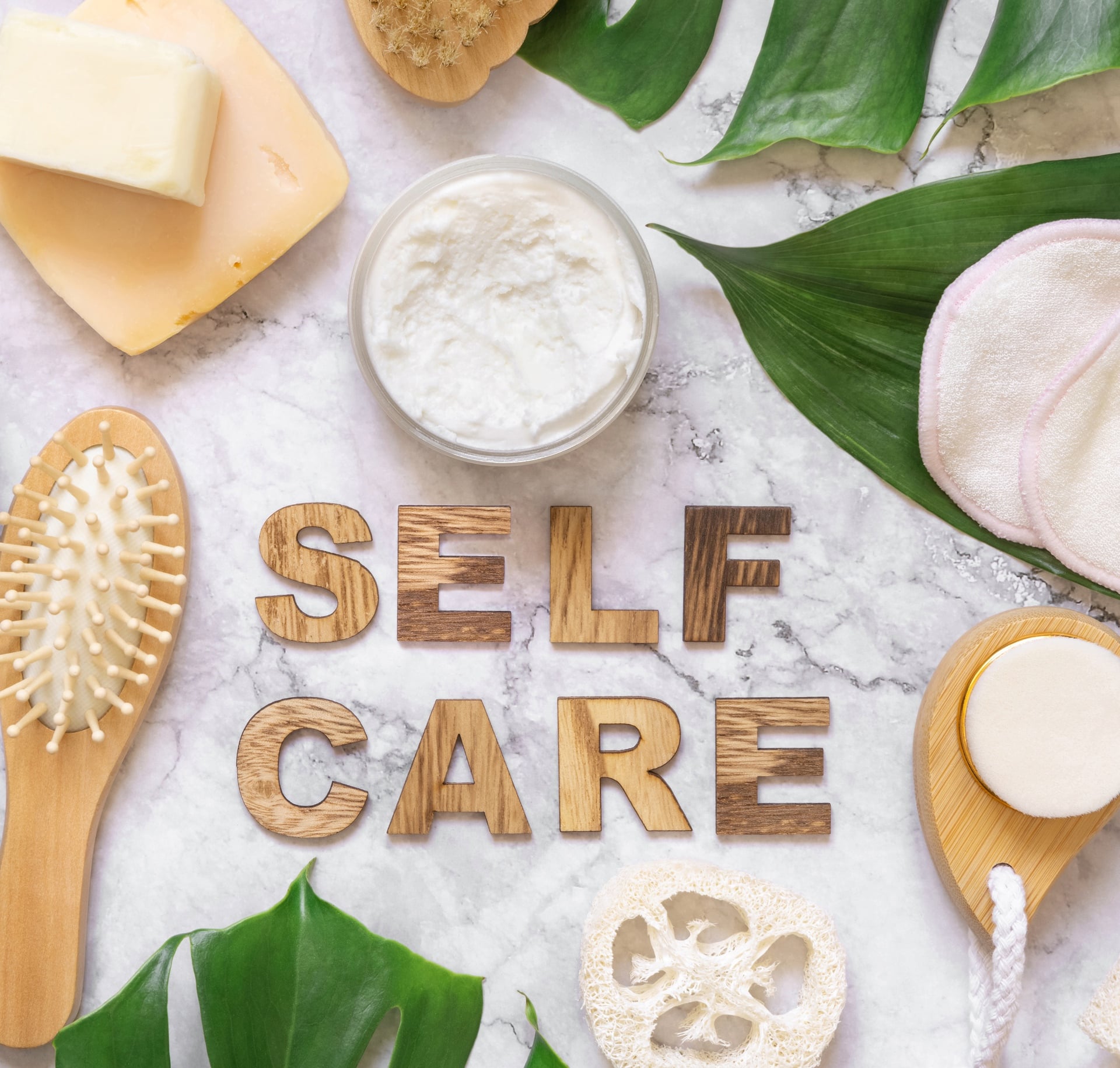 Self Care text near cosmetics, skin and hair care accessories.